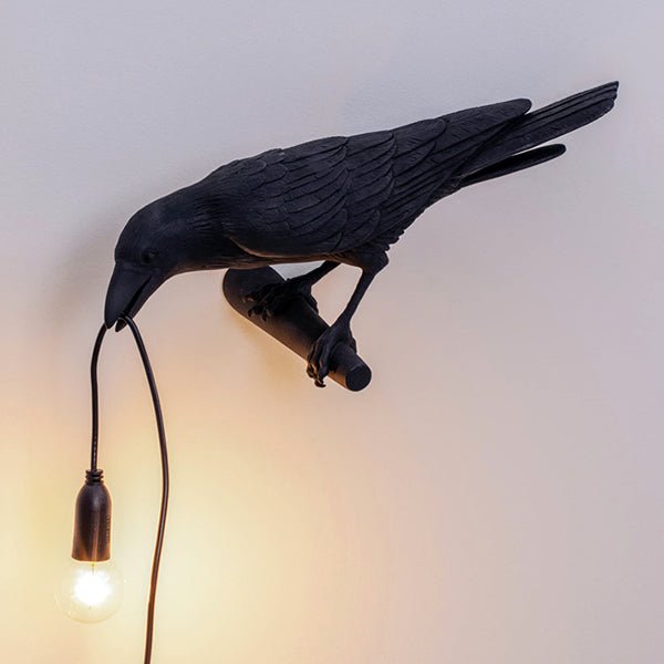 Black bird lamp perched on a shelf edge