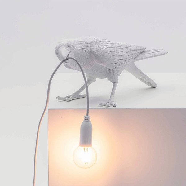 White resin bird lamp with hanging bulb cord