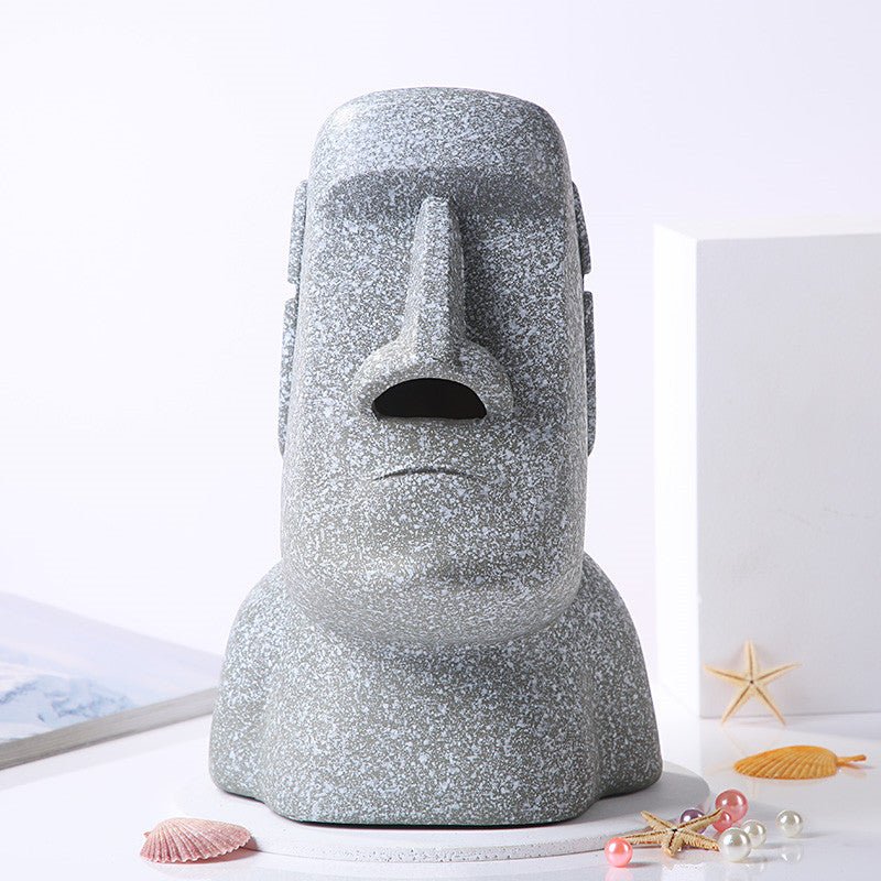 Grey Moai tissue box holder with nose opening and no tissue